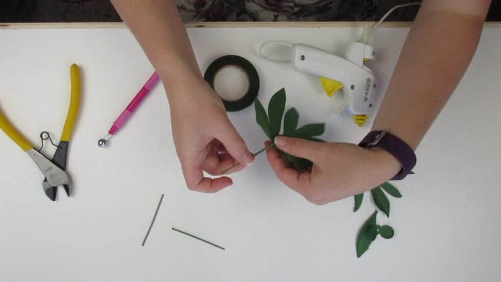 gluing the leaves of the paper peony to the wire