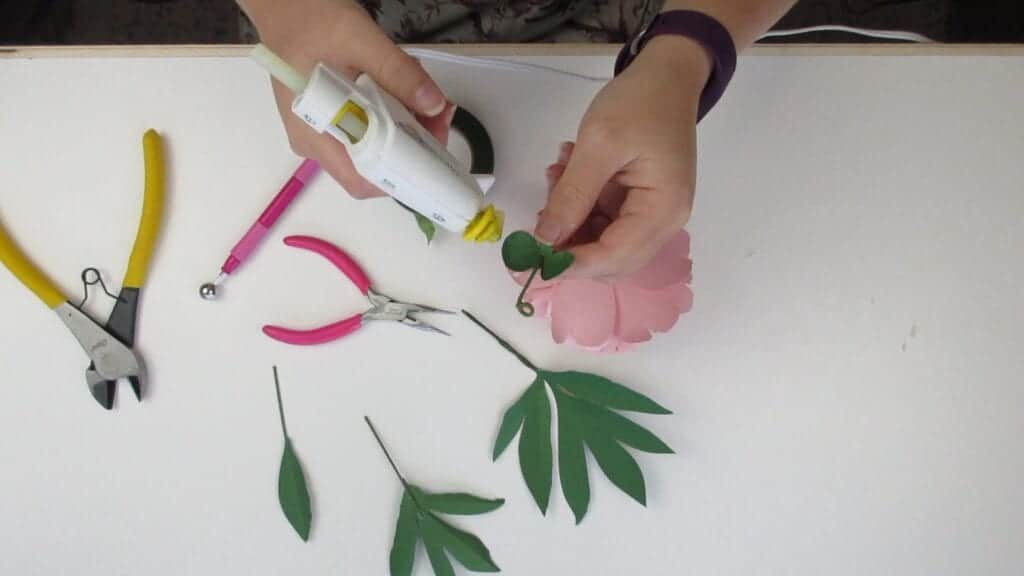 gluing the paper peony onto the stem