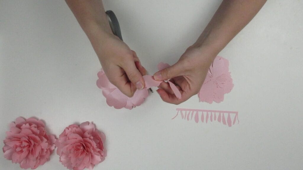 Curling the petals of the paper peony with scissors