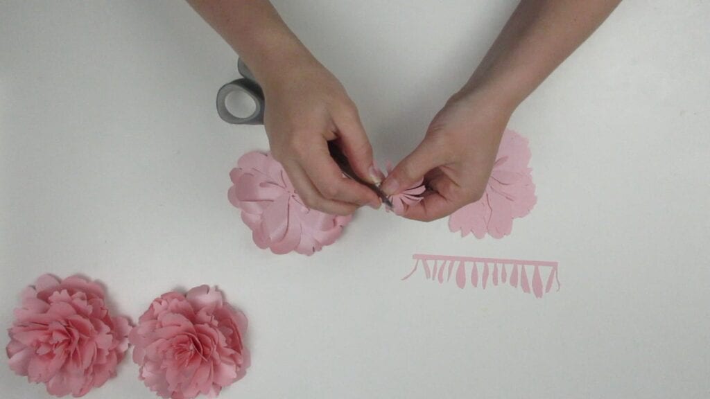 Curling the petals of the paper peony with scissors