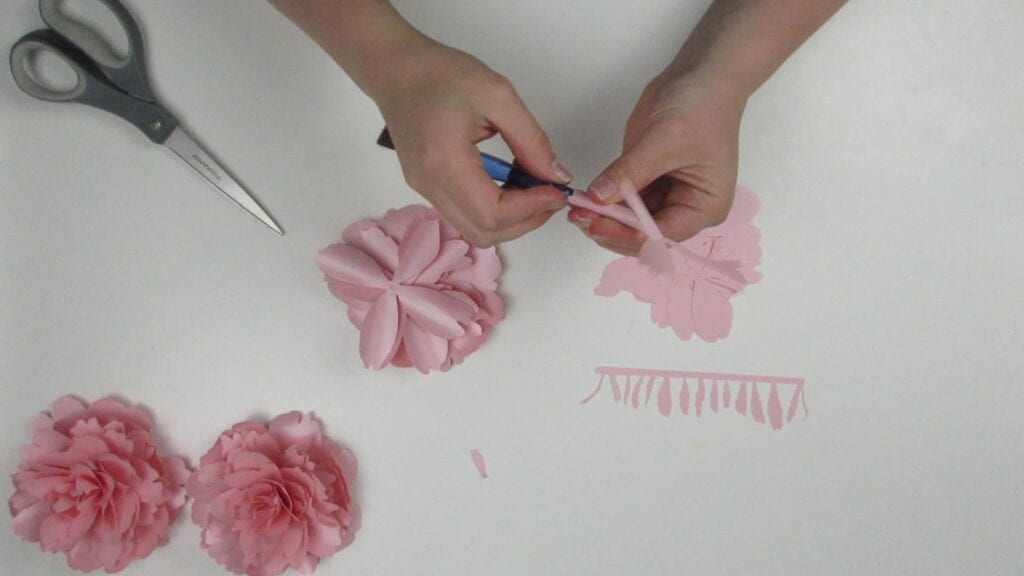 Curling the petals of the paper peony with a paintbrush