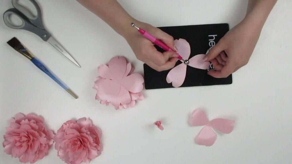 giving the petals of the paper peony some shape with a shaping mat