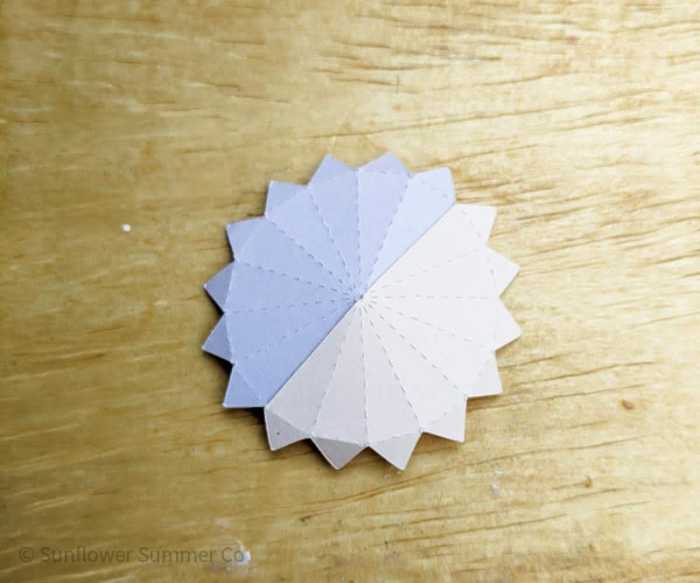 glue the first two pieces of the paper sphere together