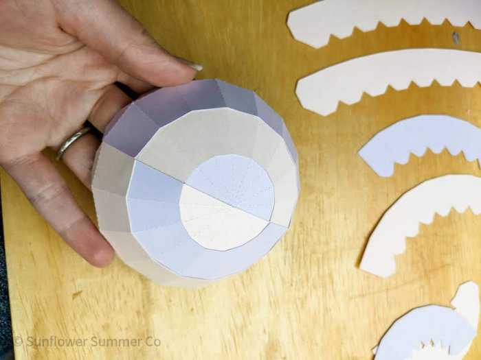 keep forming the paper sphere by adding the paper strips
